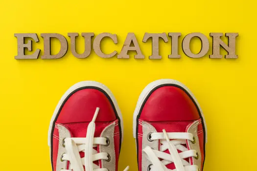 yellow background with the word education and red shoes on it