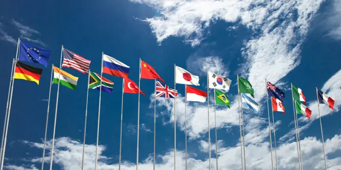 Photo of 20 flags from different countries on poles, including the United States & Japan