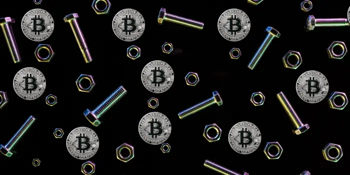 Image of nuts & bolts & Bitcoins on a black background