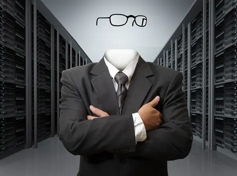 Image of a man in a suit with an invisible head wearing glasses